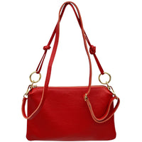 Red handbag with a strap on a white background