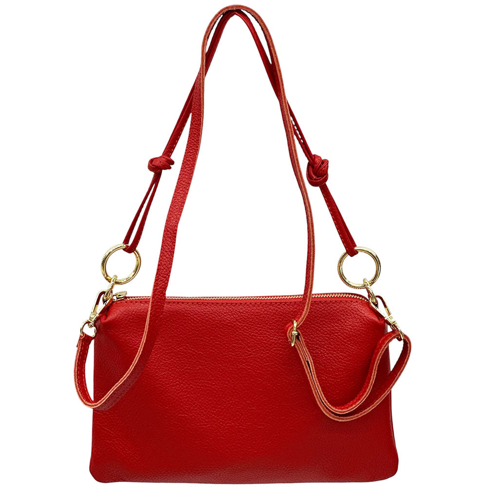 Red handbag with a strap on a white background